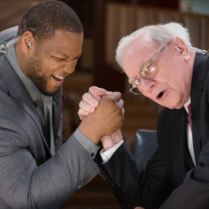 Former Detroit Lions' defensive tackle Ndamukong Suh arm wrestles with Warren Buffett, former CEO of Berkshire Hathaway.