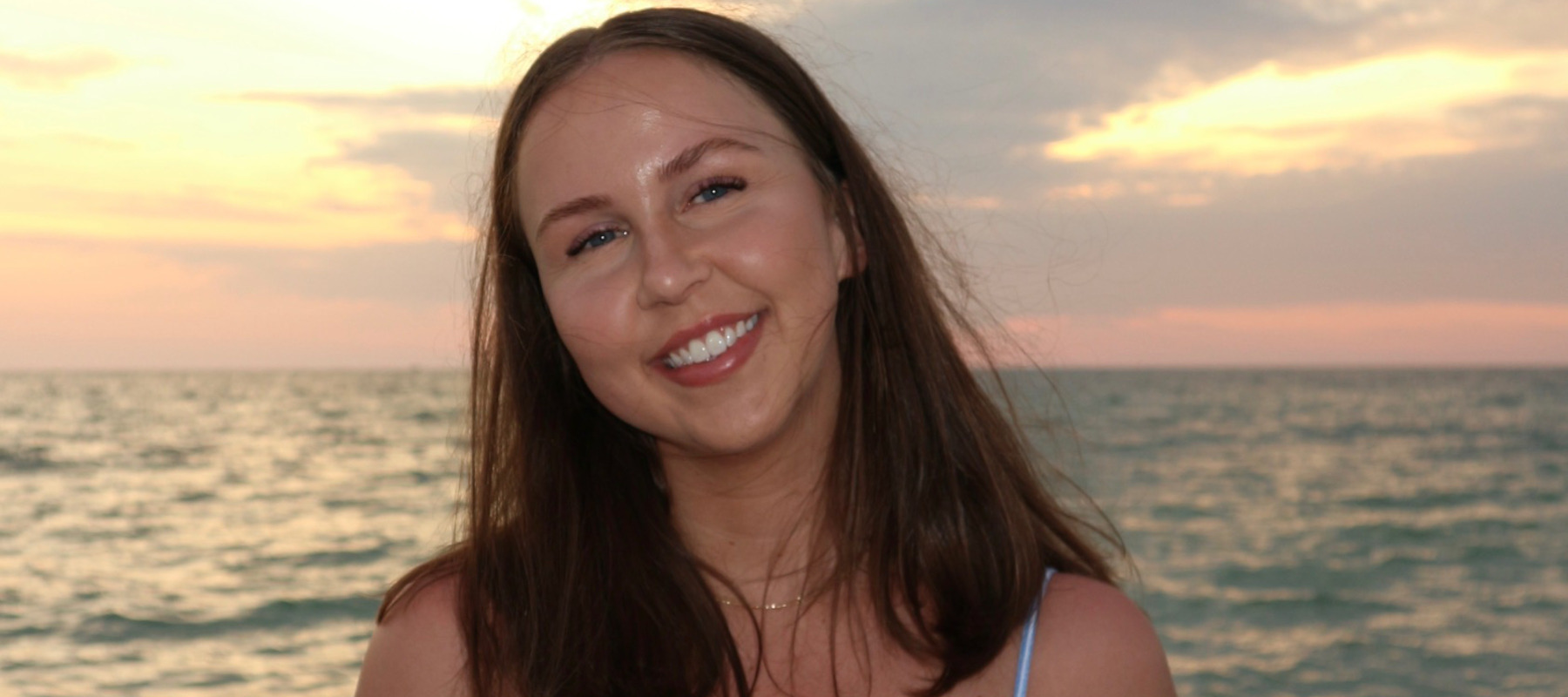 Photo of Erin Spencer in front of a sunset