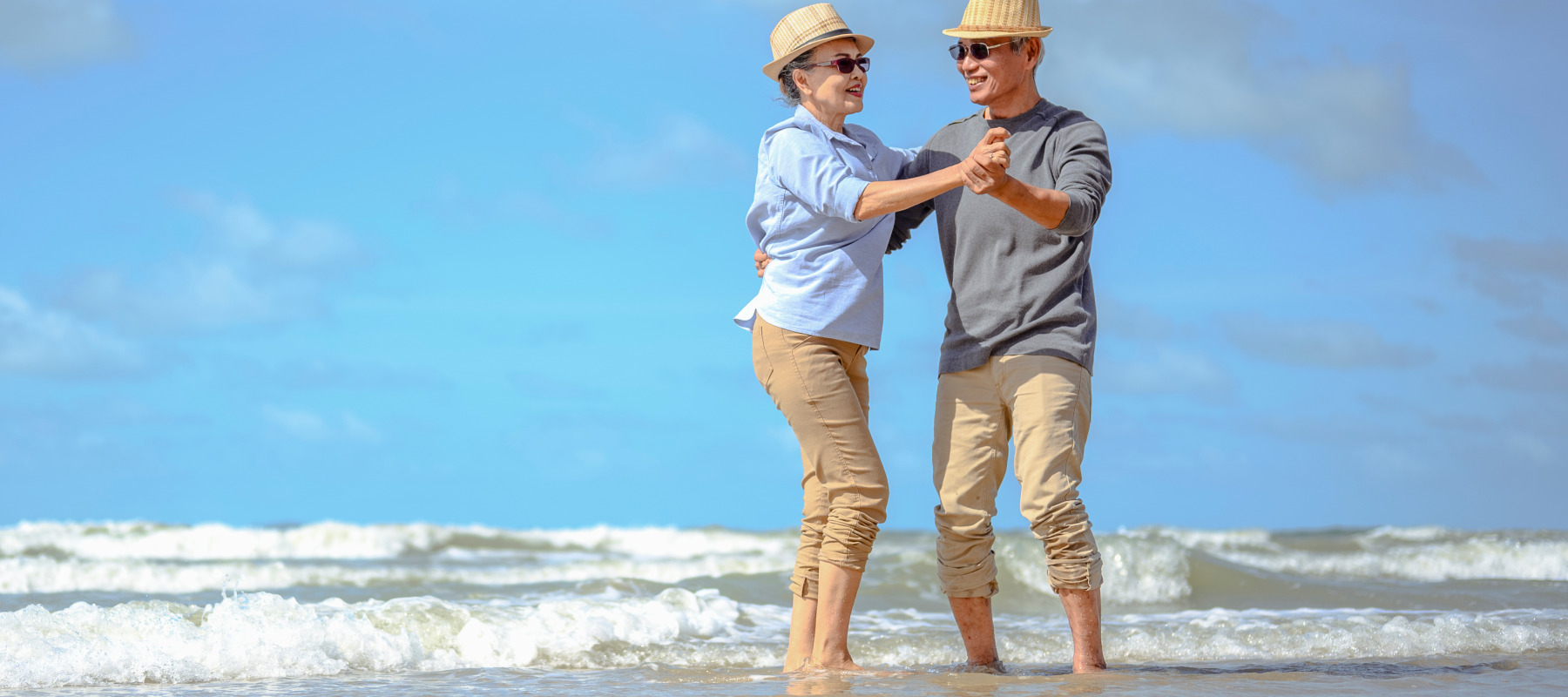 A older couple enjoying their time at the beach.