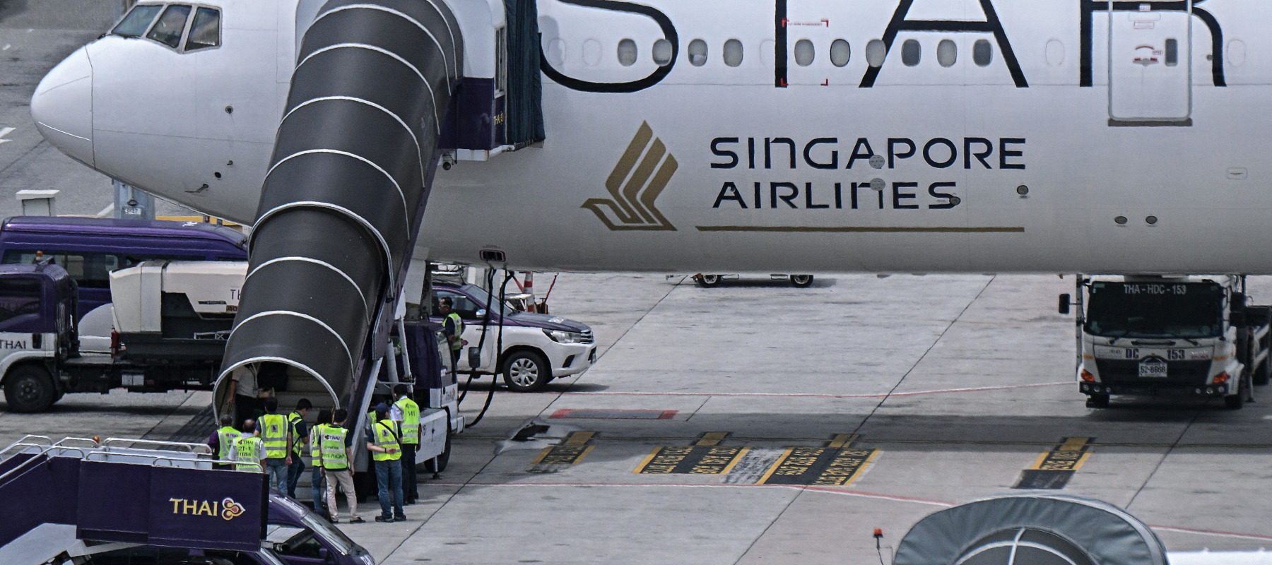 Officials enter Singapore Airlines flight flight SQ321, which was headed to Singapore from London before making an emergency landing in Bangkok due to severe turbulence.