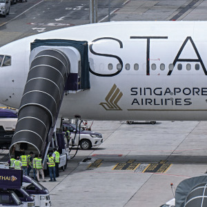 Officials enter Singapore Airlines flight flight SQ321, which was headed to Singapore from London before making an emergency landing in Bangkok due to severe turbulence.