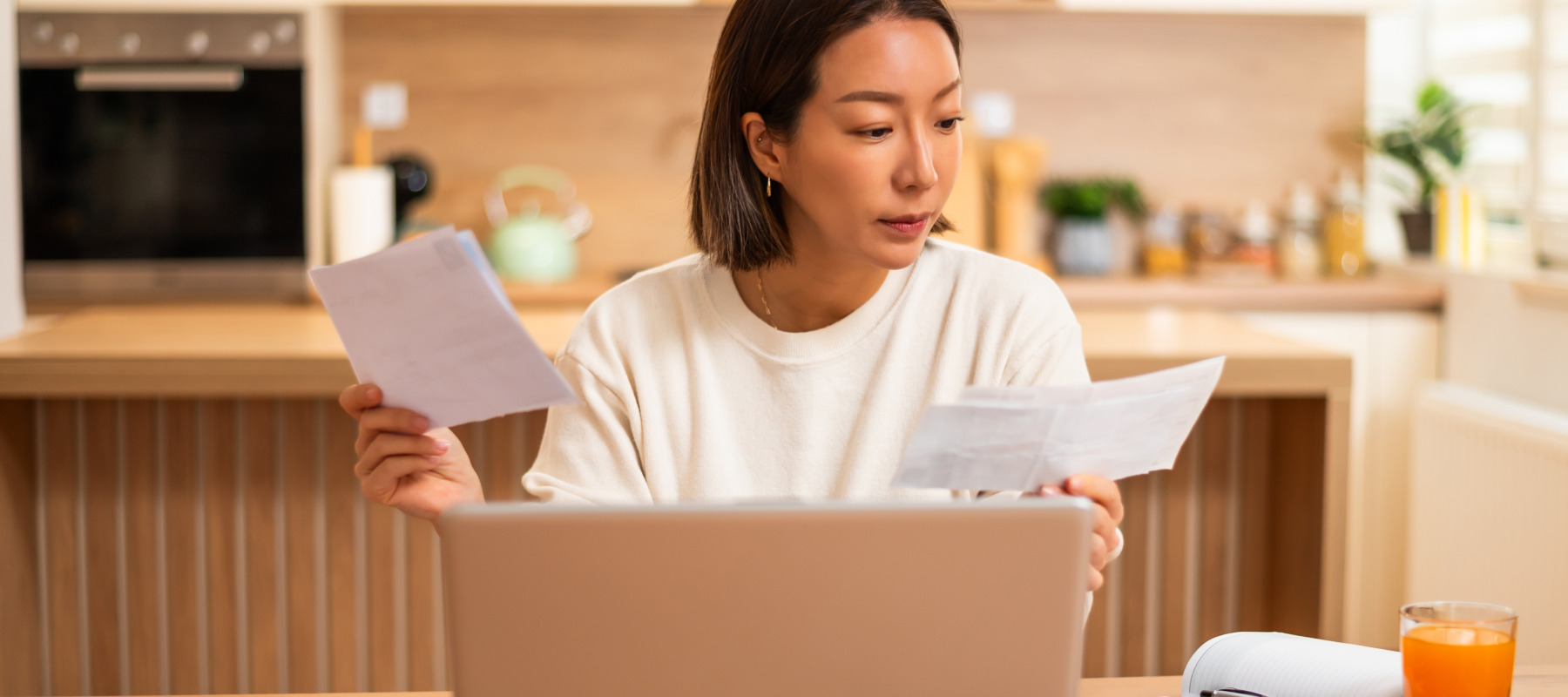 An adult woman looking over her finances.