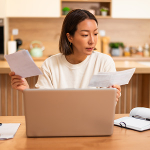 An adult woman looking over her finances.