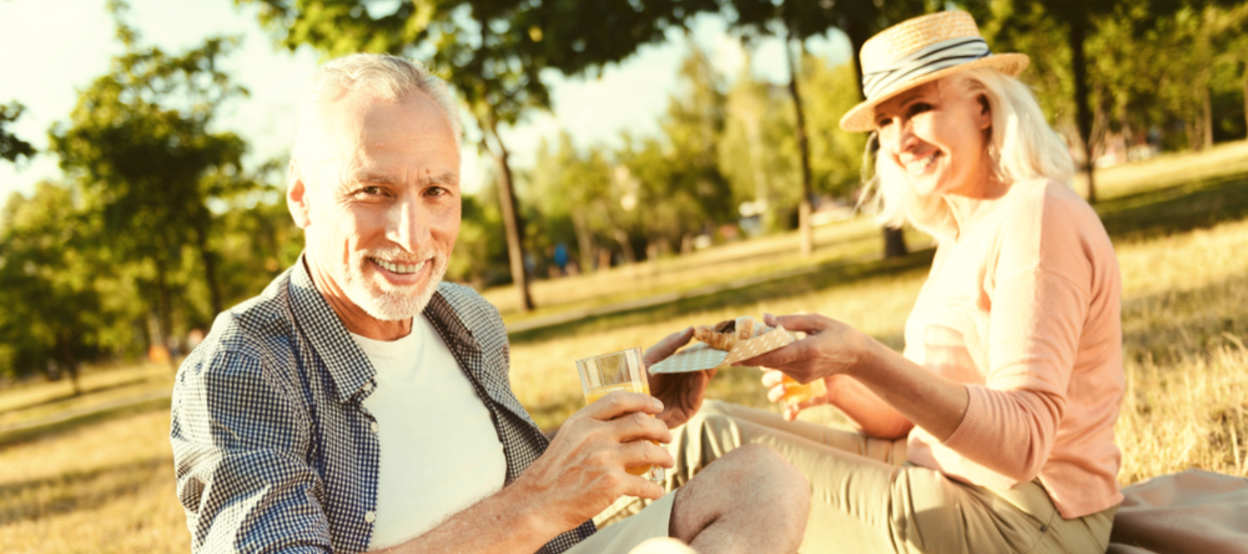 Photo of an older couple enjoying a picnic