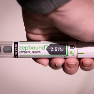 Hand of a patient using the injectable GLP-1 medication Zepbound.