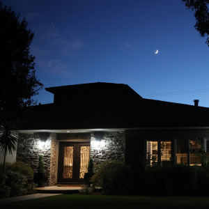 Bungalow home in San Jose, California seen from outside at night.
