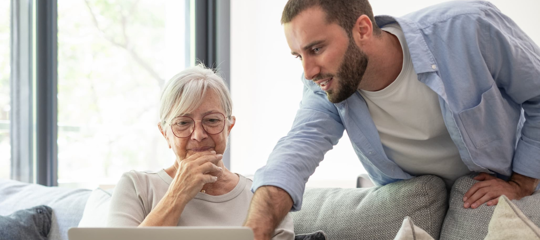 A photo of an elderly woman and her adult grandson