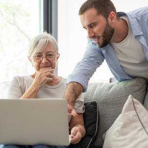 A photo of an elderly woman and her adult grandson