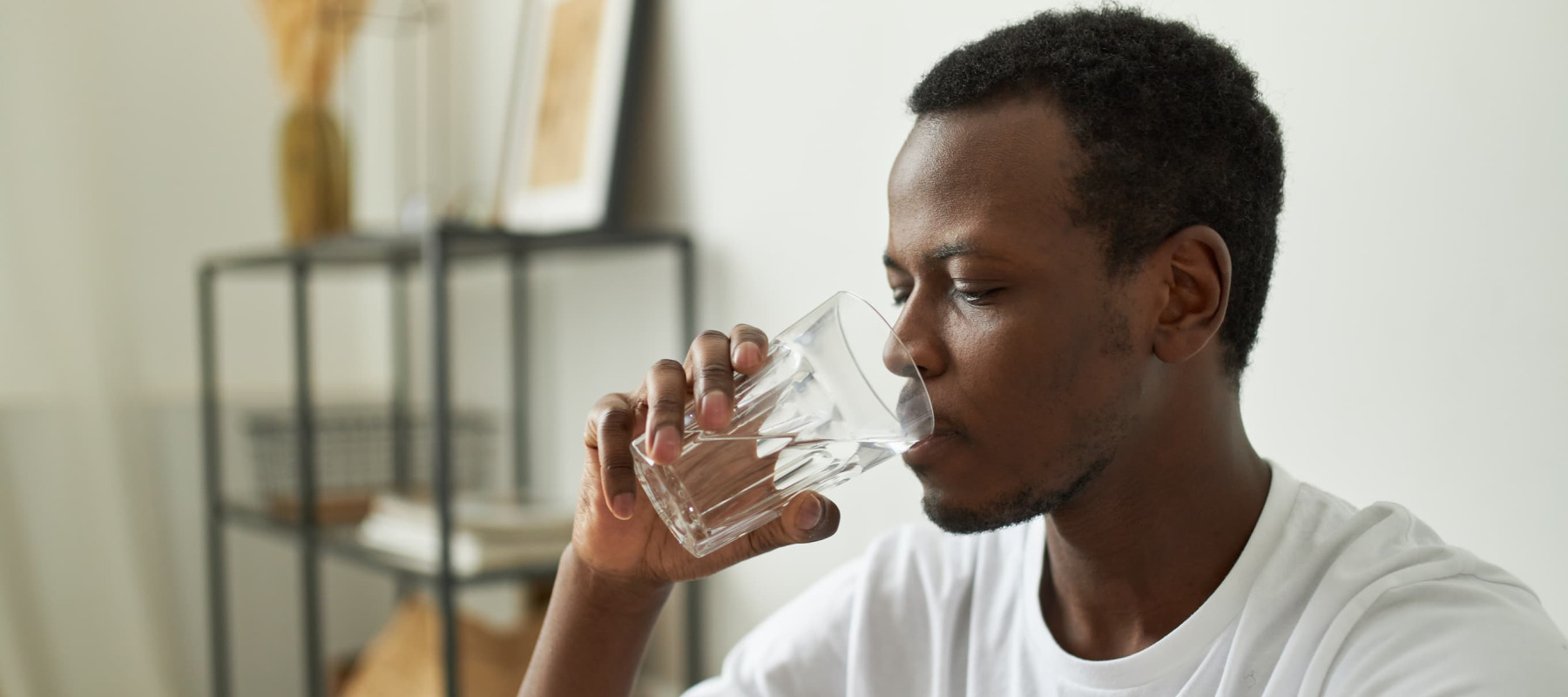 A photo of a man drinking water