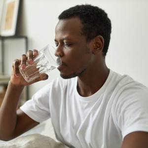 A photo of a man drinking water