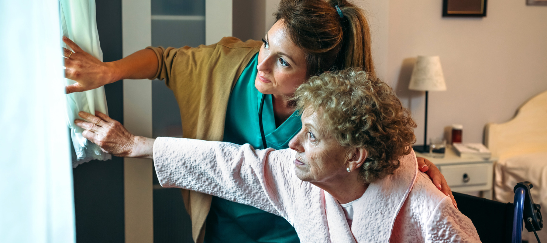Female caregiver taking care of elderly woman