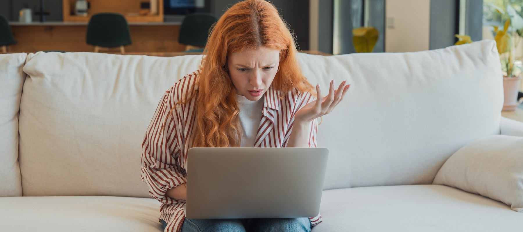 Confused woman looking at her laptop.