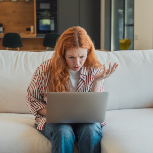 Confused woman looking at her laptop.