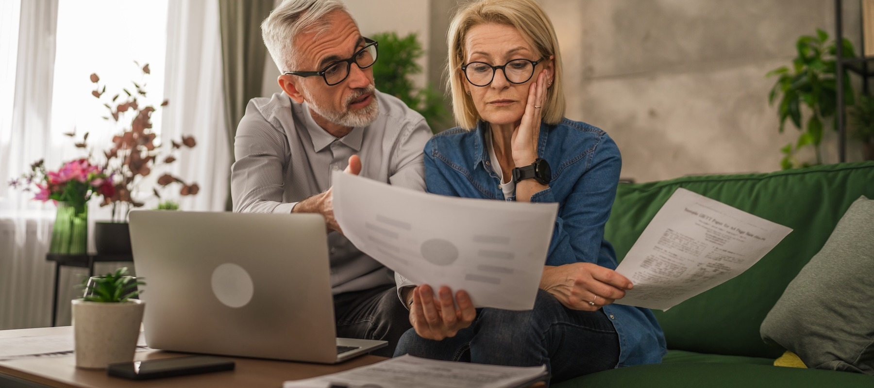 Stressed couple looking at their finances.