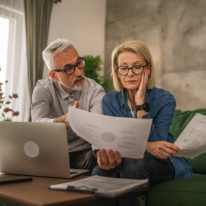 Stressed couple looking at their finances.