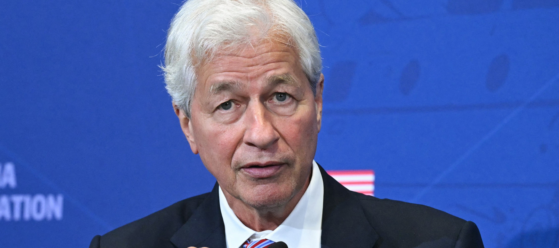 Jamie Dimon, CEO of JP Morgan Chase, speaks alongside US President Donald Trump.