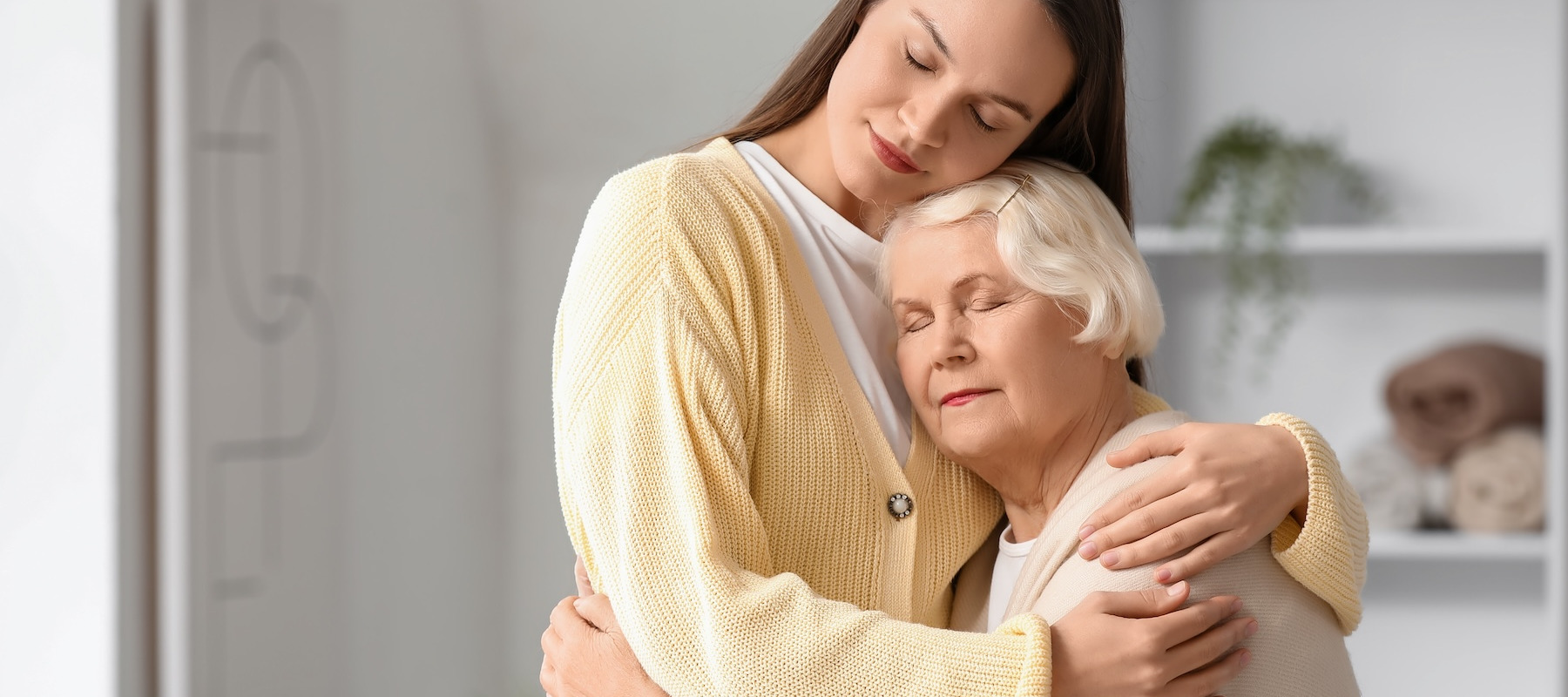 Granddaughter and grandmother hugging.