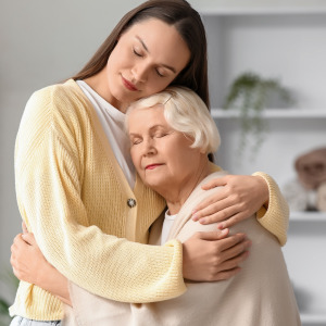 Granddaughter and grandmother hugging.