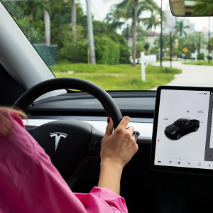 Woman driving a Tesla