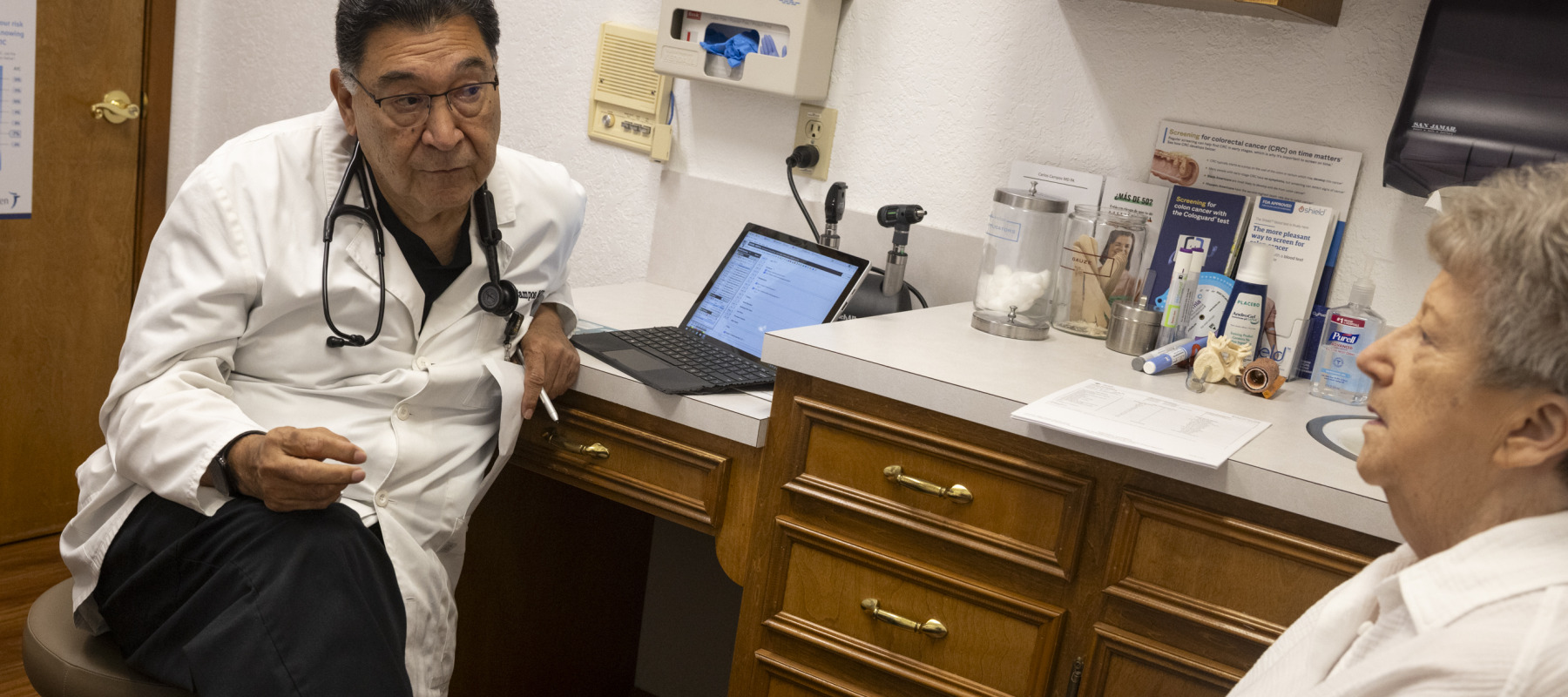 Dr. Carlos Campos, who speaks about the benefits of GLP-1 medications, speaks with a patient.
