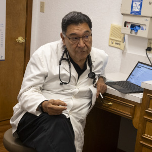 Dr. Carlos Campos, who speaks about the benefits of GLP-1 medications, speaks with a patient.