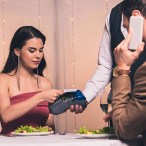 Woman paying for her own dinner on a date.