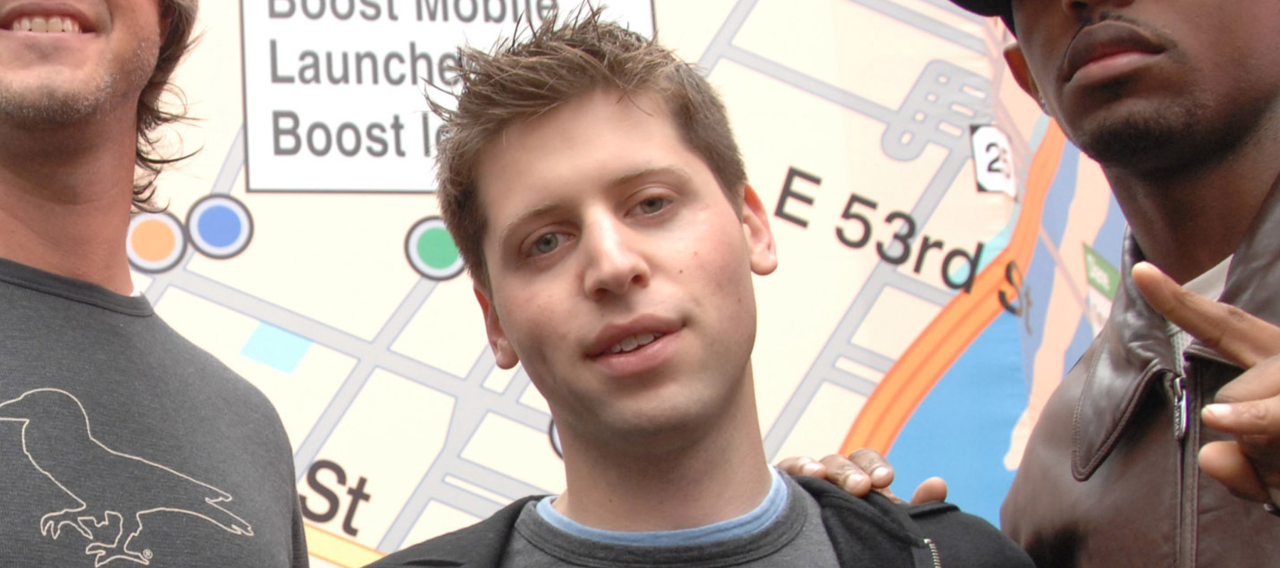 Sam Altman surrounded by Craig Thole of Boost Mobile (left) and the rapper Fabolous