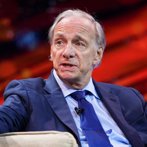 Ray Dalio argues passionately from a chair on stage