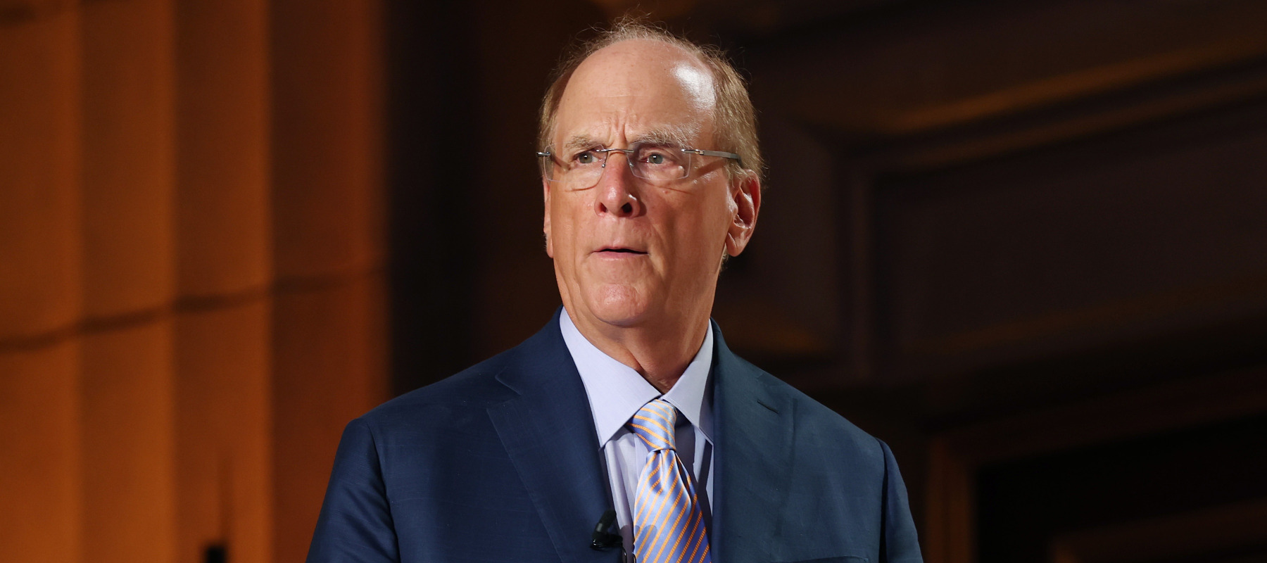 Blackrock founder Larry Fink looks serious walking out on stage