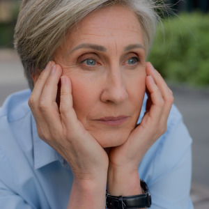 Woman stares off into the distance, stressing about the future of Social Security.