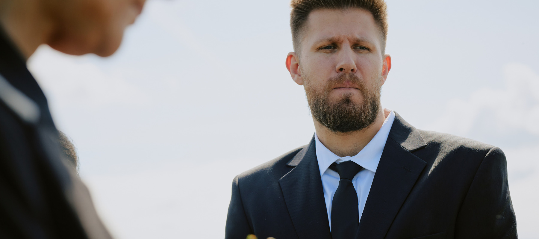 Groomsman looking annoyed at wedding