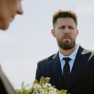 Groomsman looking annoyed at wedding
