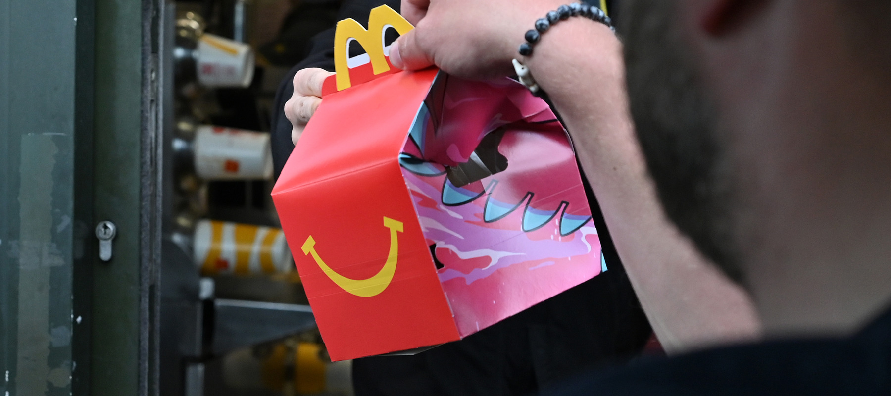 Person getting Happy Meal in McDonald’s drive thru