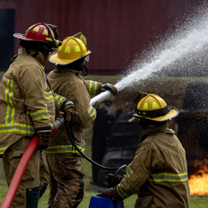 Three firefighters put out a fire at a residential building.