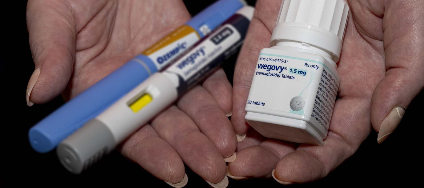 A GLP-1 user holds their medication in their hands.