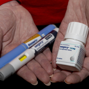 A GLP-1 user holds their medication in their hands.