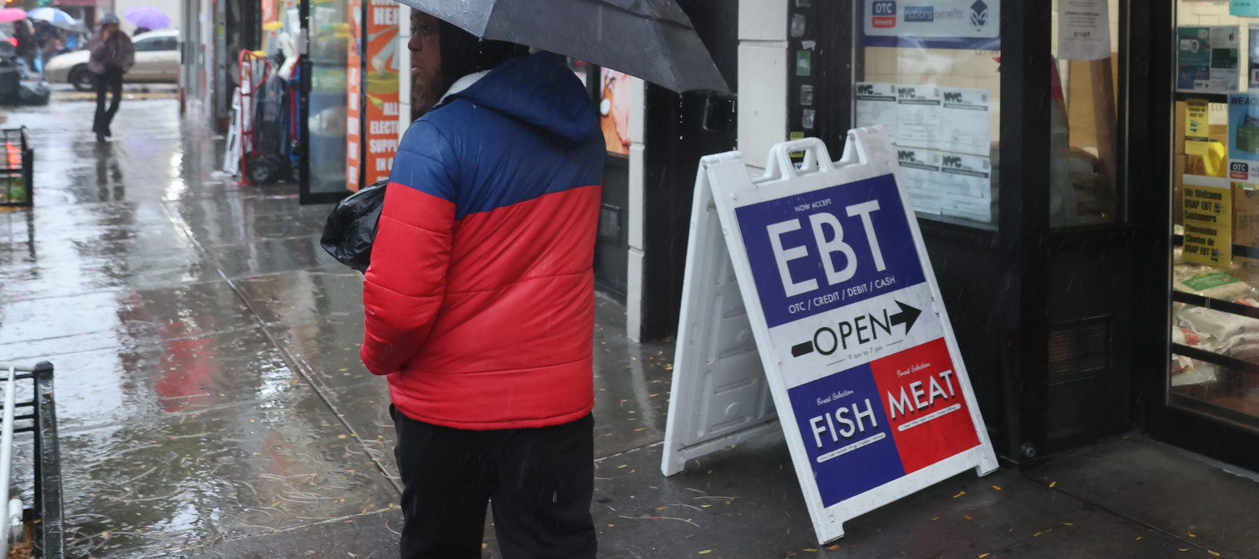An EBT sign is displayed on the window of a grocery store in the Flatbush neighborhood of the Brooklyn, New York City.