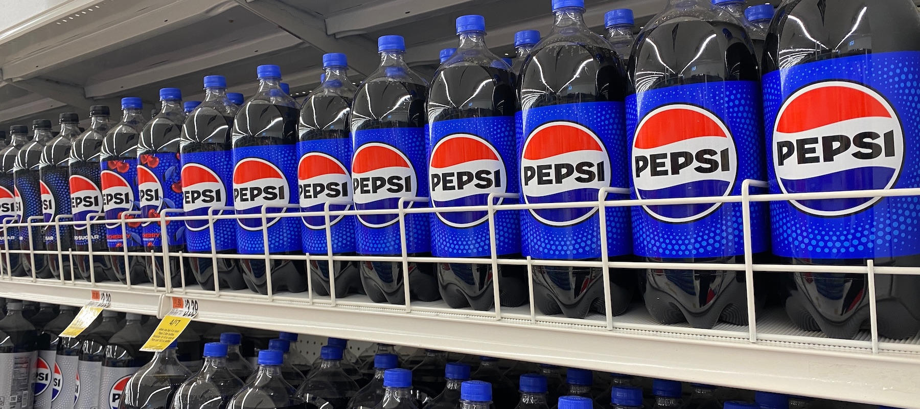 Bottles of Pepsi in a grocery store.