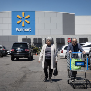 An elderly couple walks through a Walmart parking lot in Chicago, Illinois.