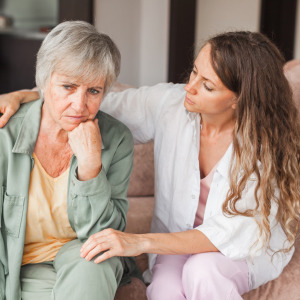 Daughter comforting her stressed mother.