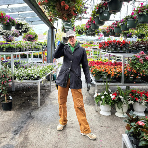 Leslie Friday stands in her uniform at her former garden center job.