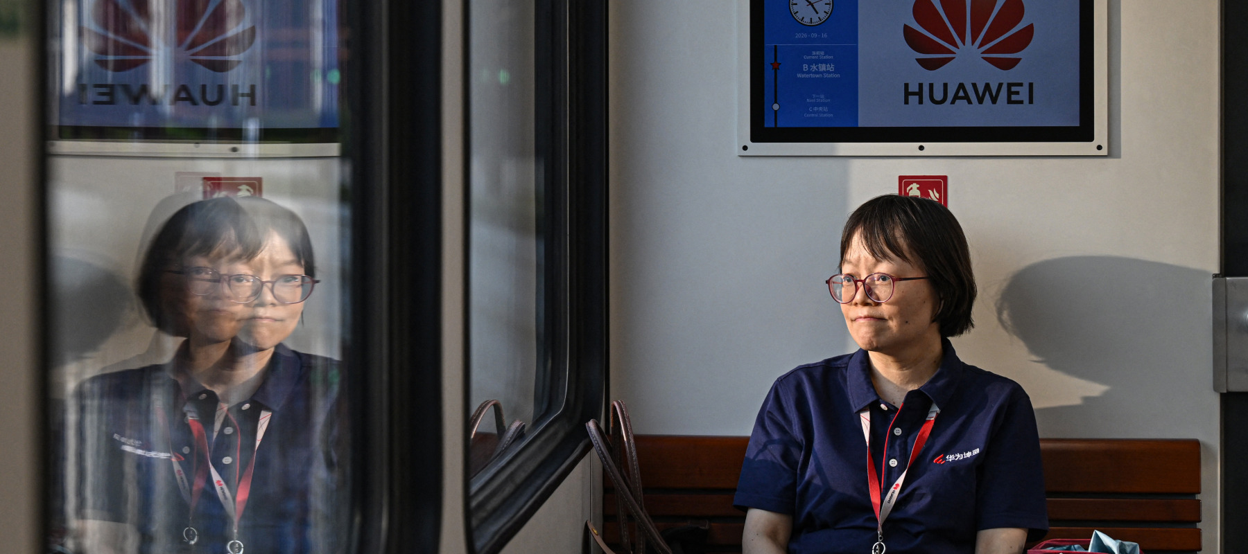 A Huawei employee travels on a shuttle train at Huawei Lianqiu Lake research campus during a media tour in Shanghai.
