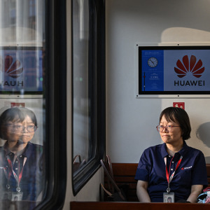 A Huawei employee travels on a shuttle train at Huawei Lianqiu Lake research campus during a media tour in Shanghai.