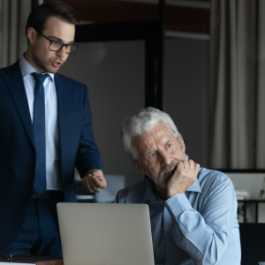 A photo of two men talking in the office