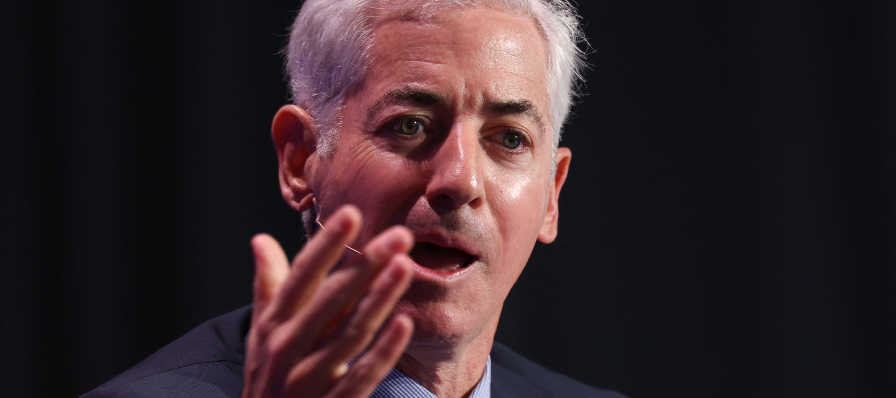 Bill Ackman holds his hand out in frustration.