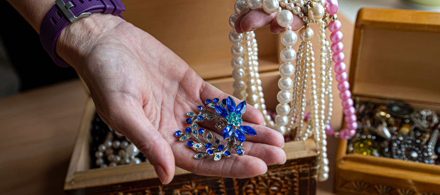 Woman holding jewelry from box