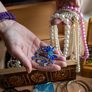 Woman holding jewelry from box