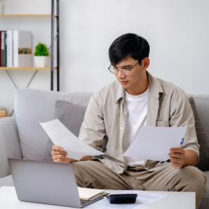 A photo of a man reviewing paperwork