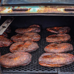 Two-panel image of Butter's BBQ in Sinton, Texas and cooked briskets in a smoker.