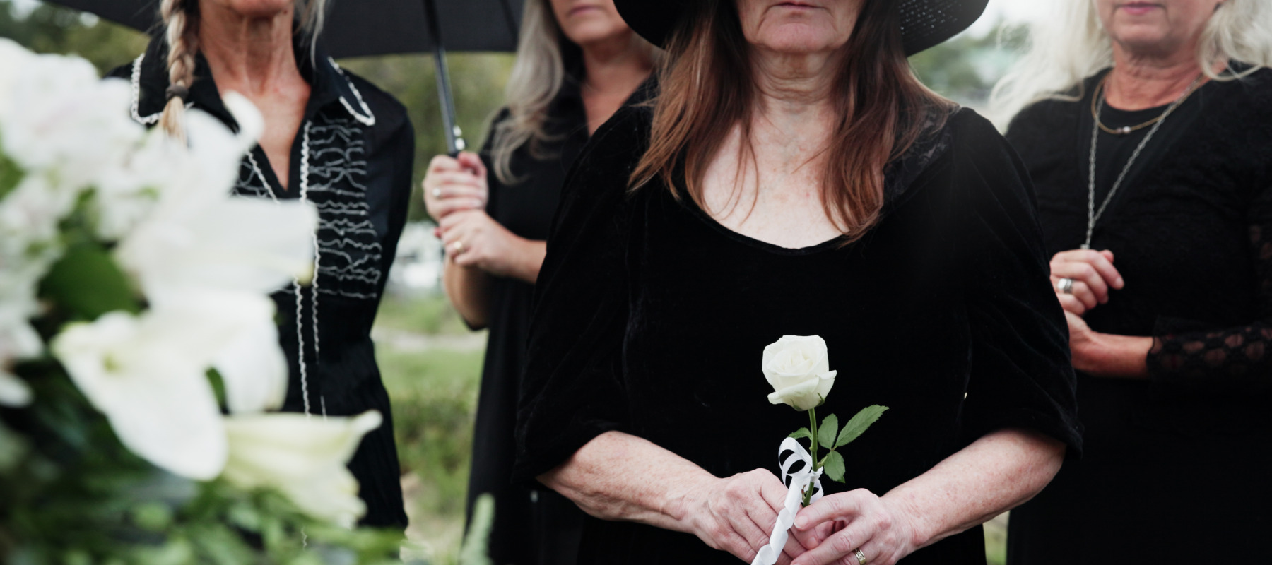 Women mourning at parents' funeral